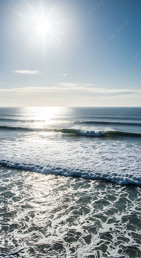 Fototapeta premium Sun-drenched ocean waves, showcasing a serene coastal scene with brilliant light reflecting on the water's surface.