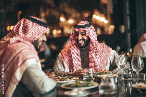 Two Friends Enjoying Dinner Together in a Cozy Restaurant During the Evening in Saudi Arabia