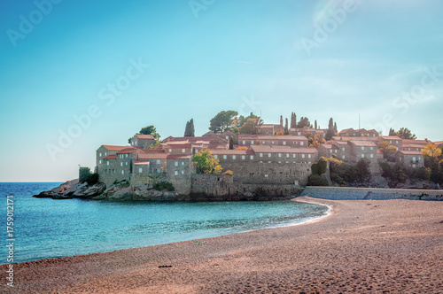 Sveti Stefan beach and Sveti Stefan island, connected to the mainland with a narrow causeway. A landmark on the Adriatic coast of Montenegro.