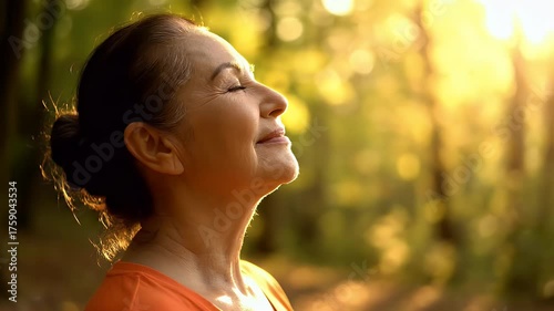 Woman enjoying a peaceful moment in nature with sun shining through trees.