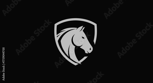 Horse head profile within shield on black backdrop
