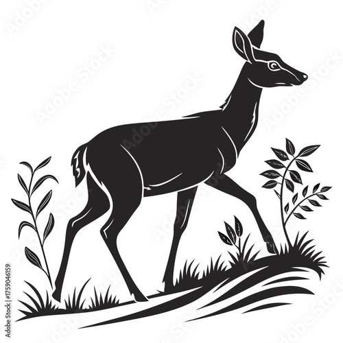 Elegant deer silhouette grazing in a field of grass and leaves