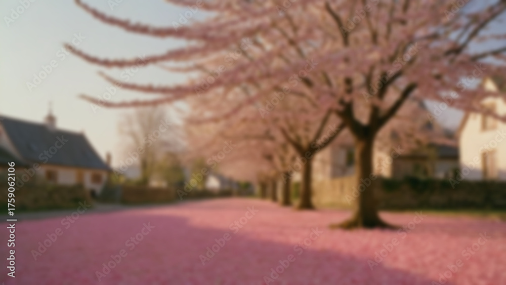 Obraz premium background blurred A cherry tree in peak bloom, pink petals on ground, small village behind, late afternoon, golden soft light, 70mm, slow pan right, Portra 400 sim, petals drifting.