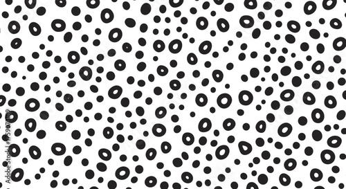 An abstract pattern of small circles and dots in black and white.