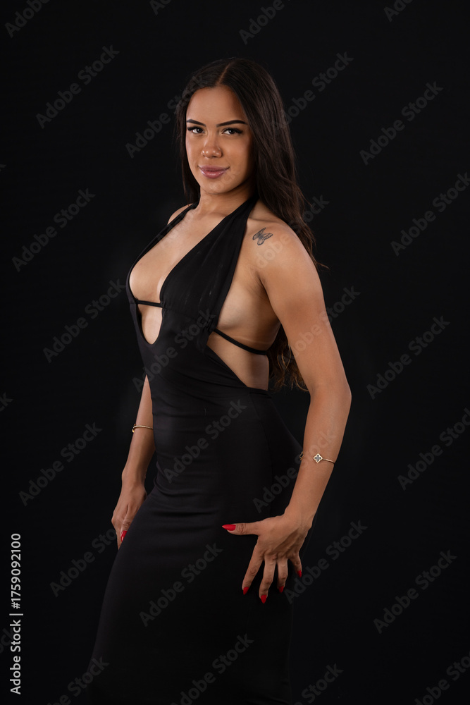 Fototapeta premium young woman in sexy red dress in studio photo with black background