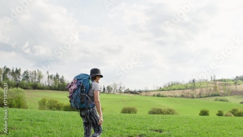 4K footage of middle aged woman hiking with backpack on green grass meadows in Slovakian mountains active people sporty lifestyle summer nature concept