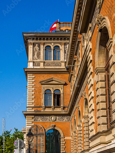Vienna, Austria – April 30, 2024: Historic façade of the Museum of Applied Arts (MAK: Museum für angewandte Kunst) with Austrian flag
