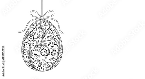 A beautifully ornate black and white Easter egg with intricate floral swirling patterns hangs from a bow and ribbon against a white background.