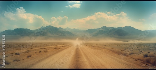 Panoramic view of a vast desert landscape with dust clouds swirling around and mountains in the distance