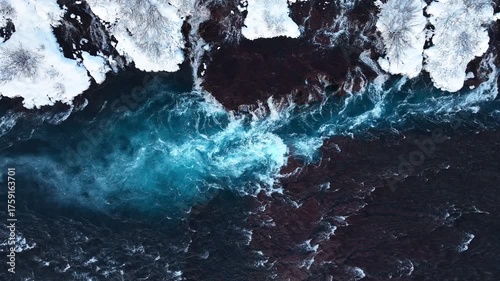 River in Iceland, Snowy Hills and Waterfalls in Winter, Magical Blue Glacial Water with a Huge Current. Hraunfossar