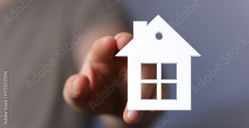A hand gently holding a whi...
