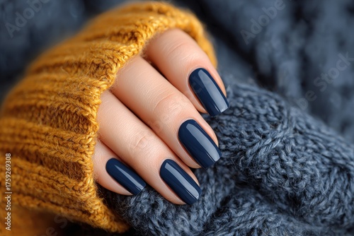 Elegant hand with long nails and dark blue polish