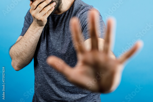 A man covering his face and...