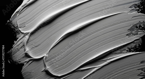 Abstract Swirls of Gray Cream or Clay Texture Against a Black Background for Beauty or Cosmetic Product Promotion and Design