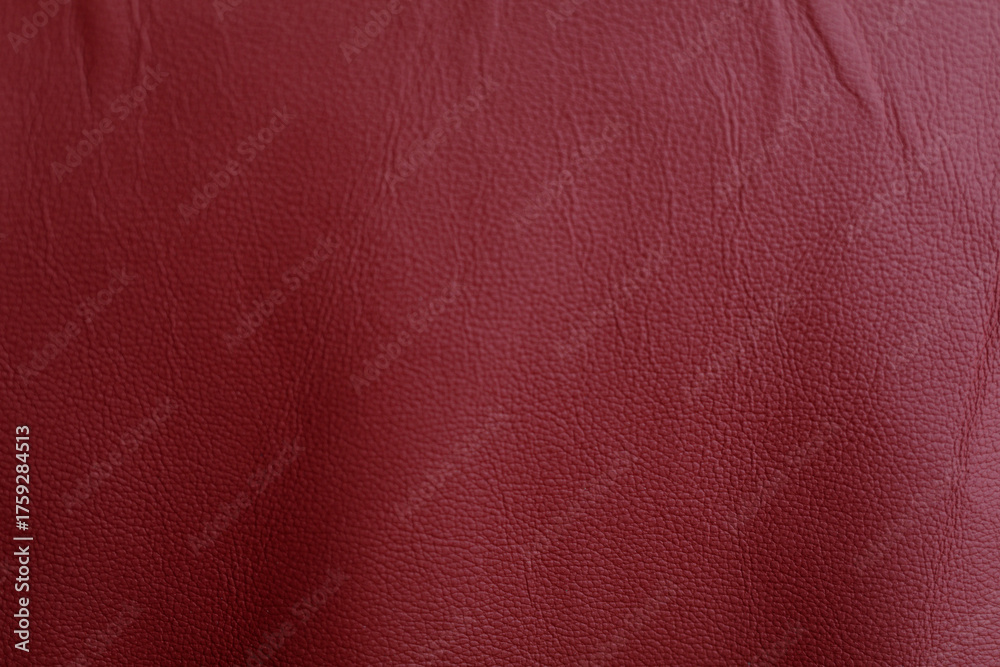 Fototapeta premium Red leather texture background, perfect for use in various design projects. Ideal for backgrounds, textures, and abstract design concepts. Offer
