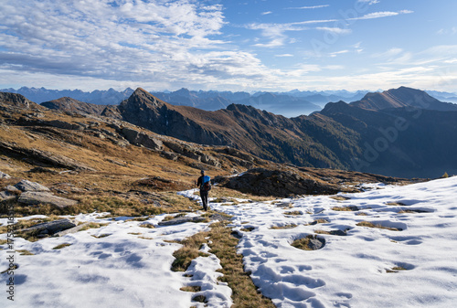 A woman hiking in the Ticino mountains on a beautiful, autumn day.