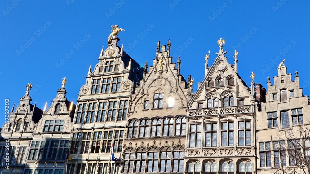 Obraz premium Ornate guildhalls lining Grote Markt in Antwerp, Belgium, historic architecture under clear blue sky