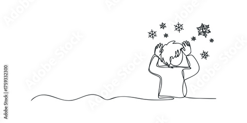 Person with hands on head watching snowflakes fall