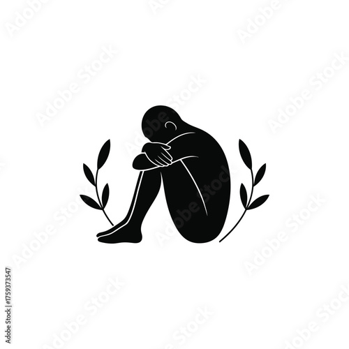 Solitary figure embracing knees surrounded by delicate branches