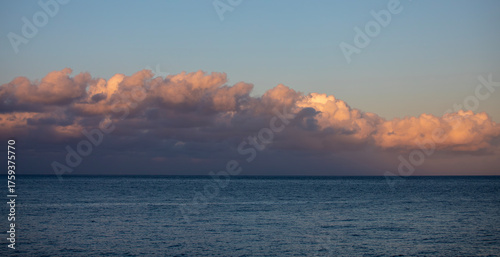 Sunset over the Pacific Ocean with a ship in the distance.