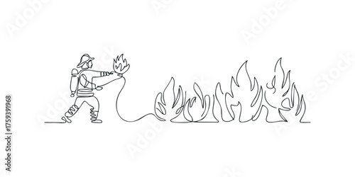 Firefighter spraying water on a line of flames