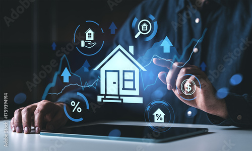 Real estate investment concept with digital hologram house and financial icons on tablet interface by businessperson in modern workspace..