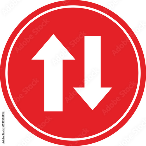 Red circular traffic sign with white arrows indicating two way traffic or opposing directions