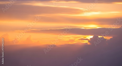 Breathtaking aerial view of a vibrant sunset with clouds and a warm orange glow above the horizon.