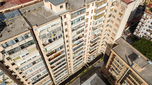 Aerial view of residential buildings. Condominium building with many balconies and windows.