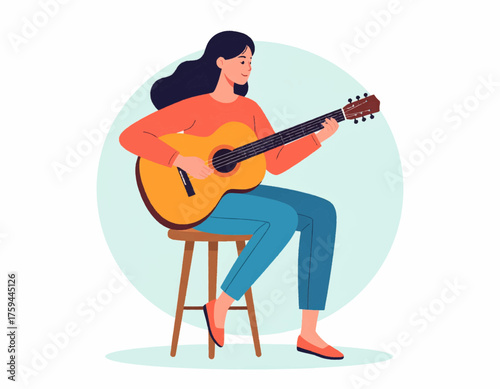 A young woman with long dark hair sits on a wooden stool while playing an acoustic guitar.