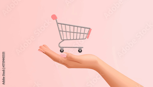 A hand holding a miniature shopping cart against a soft pink background, symbolizing online commerce.