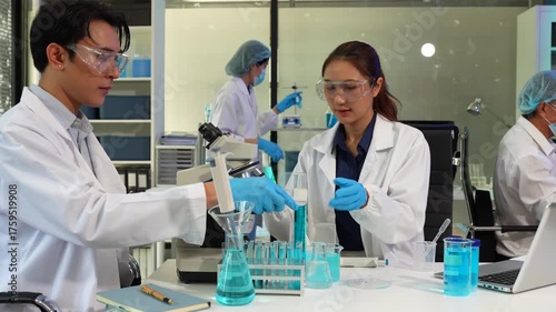 Scientists conducting research in a biotechnology lab, using pipettes and test tubes for medical and chemical experiments. Innovation in chemistry, healthcare, and medicine.