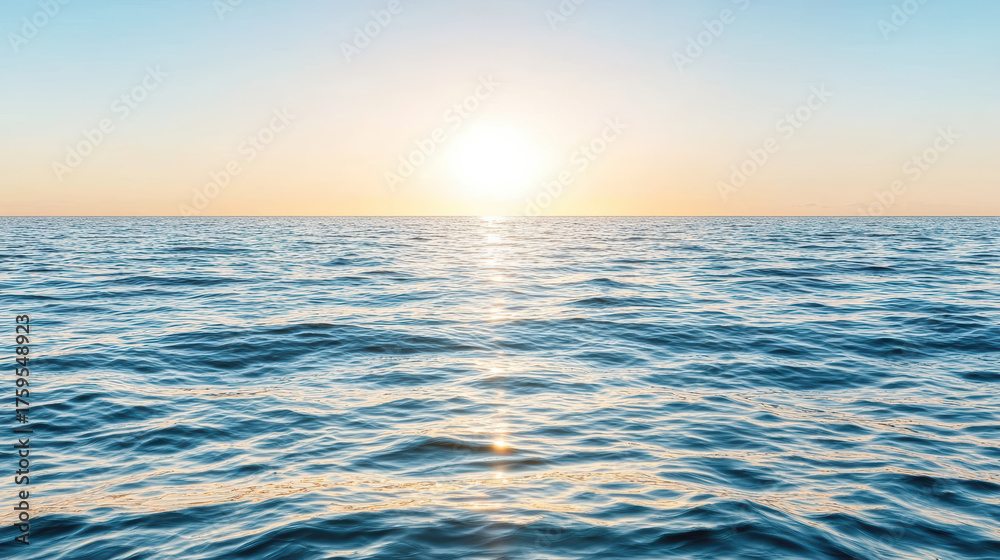 Obraz premium Calm ocean waves reflect sunlight under pastel sky, creating peaceful atmosphere