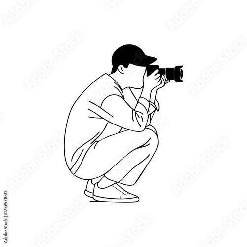 A photographer crouching while taking a picture, representing creativity, focus, and professional photography work.