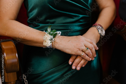 Bild auf Leinwand Close-up of a woman's hands wearing a jeweled wrist corsage with white flowers a