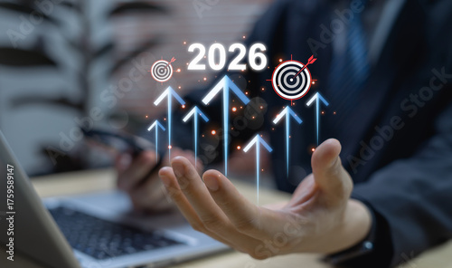 2026 business goals concept with businessman indicating rising arrows and target icon, representing future growth, strategic planning, success vision, and performance enhancement.