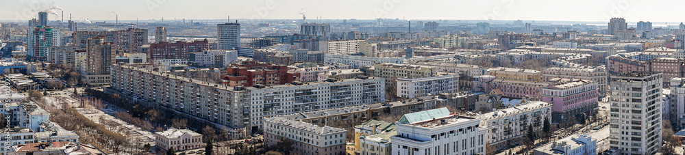 Fototapeta premium Panoramic view from above of the city of Chelyabinsk in Russia Many high-rise buildings of various types are visible, the sky is blue and clear, the weather is cold.
