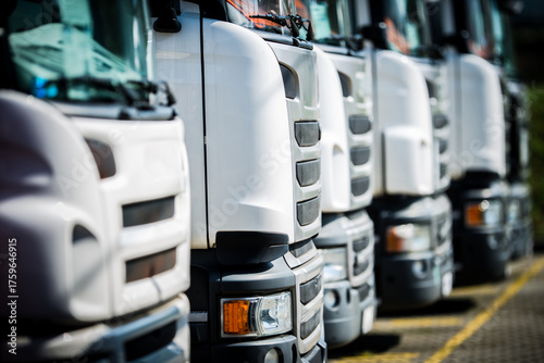 Trucks Lined up in a Storage Yard During Daytime