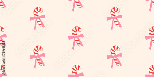 Christmas seamless pattern with cute candy canes and pink bows in a flat, hand-drawn style. Festive background for winter holidays for wrapping paper or textile, vector illustration.
