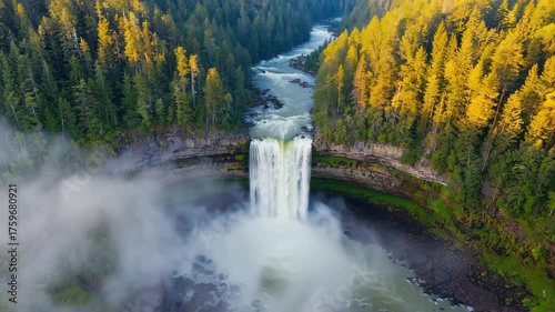 Aerial view of the majestic snoqualmie falls surrounded by lush green forest