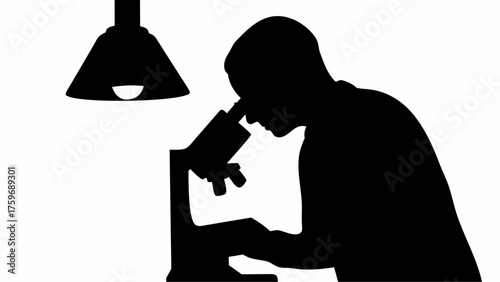 Researcher intently using microscope under focused light for scientific discovery and medical advancement research