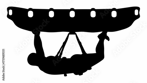 Silhouette of gymnast expertly performing on the parallel bars with strength and determination in training