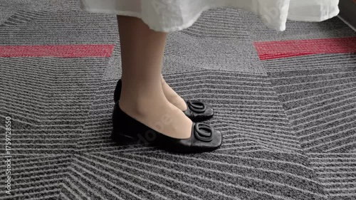 woman Relaxing at Work by Gently Bouncing Heel in Black Shoes