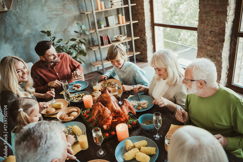 A warm family thanksgiving dinner around a big turkey with generations gathering together for a festive holiday