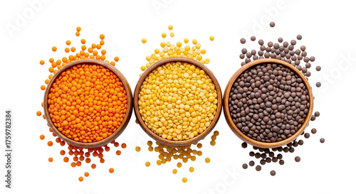 Three wooden bowls filled with different varieties of lentils on a black background with scattered lentils