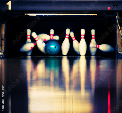 Bowling. Blue ball hits the skittles.