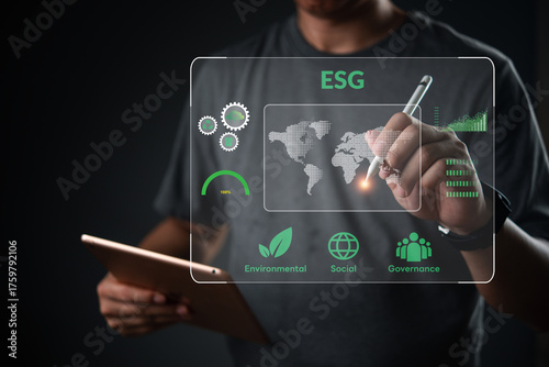 ESG concept. Man holding tablet analyze virtual dashboard. Corporate sustainability strategy, environmental social governance. Global data chart, green business development goal.