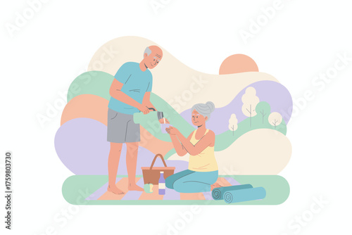 Happy senior couple enjoying a healthy outdoor picnic sharing drinks and companionship in nature