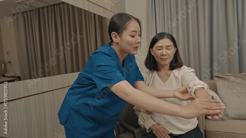 asian female caregiver assisting senior woman with physical therapy exercise at home during rehabilitation process to improve mobility strength and overall health care support in daily life