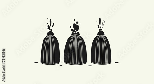 Three black decorative tassels with unique tops.